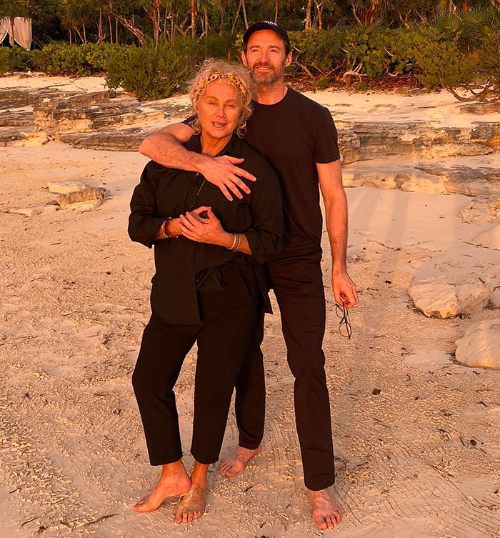 Couple on a beach, highlighting divorce snag amid sunset scene.