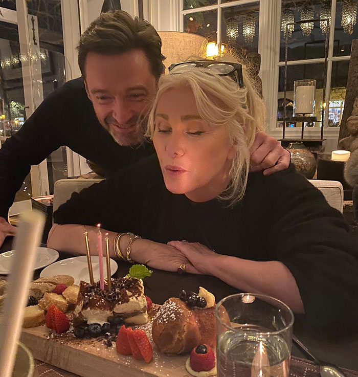 Man and woman at dinner, with candles and dessert, linked to Hugh Jackman and Deborra-Lee Furness' divorce discussion.
