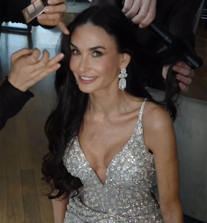 Person in a sparkling dress getting her hair styled, embodying the "Ride Of A Lifetime" theme.