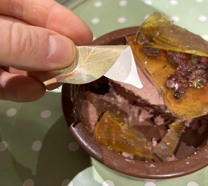 Disgusting surprise in food: a fake leaf found in a dish, revealing an unexpected discovery during a meal.