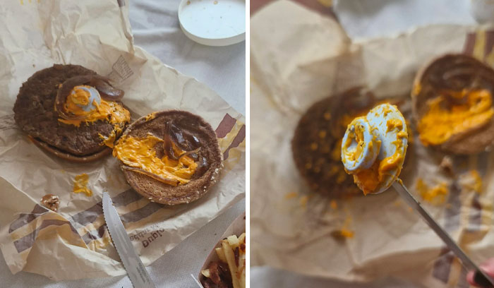 Burger bun with a plastic lid hidden under cheese, showing a disgusting food surprise.