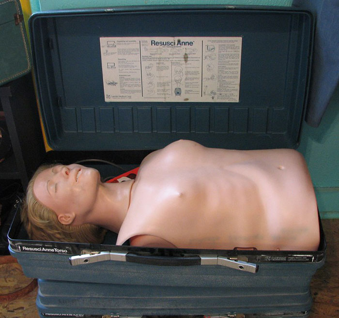 CPR mannequin torso in a suitcase, labeled "Resusci Anne," illustrating a wholesome item with a disturbing backstory.