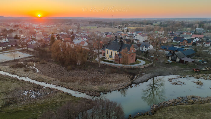 Aerial view of a quiet town with sunset, showcasing the landscape and architecture from above.