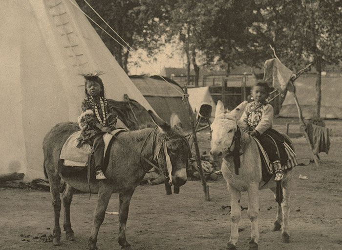 Children riding donkeys in front of a teepee, illustrating unexpected family secrets revealed by DNA tests.