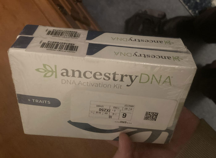 A hand holding an Ancestry DNA activation kit, highlighting DNA tests that reveal family secrets.