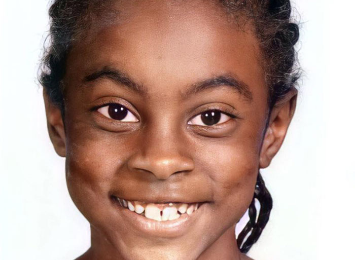 Smiling child, representing unexpected DNA test family secrets.