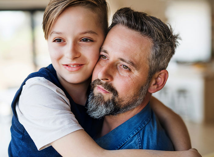 Father and son embracing, illustrating unexpected family secrets revealed by DNA tests.