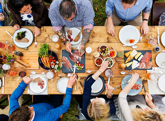 People enjoying a meal together, symbolizing unexpected family secrets revealed by online DNA tests.