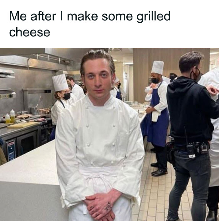 Chef in a busy kitchen, captioned about grilled cheese, embodying food-related memes humorously.