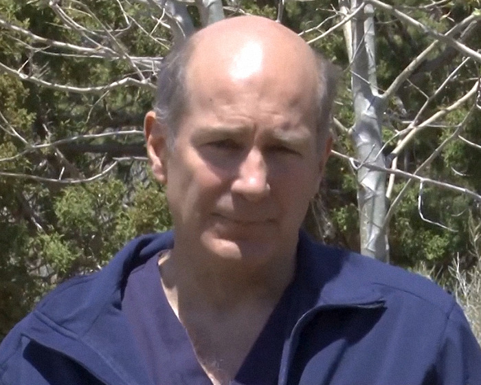 A man outdoors in a blue jacket on a sunny day, discussing timeline retraction and doctor's claim. A man outdoors in a blue jacket on a sunny day, discussing timeline retraction and doctor's claim.