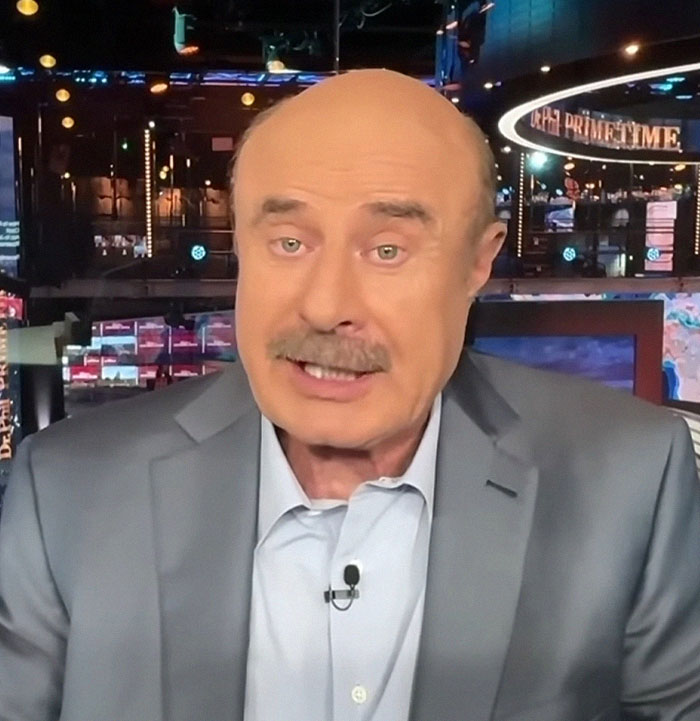 Man in a suit discussing family matters on TV. Man in a suit discussing family matters on TV.