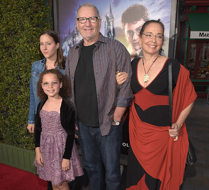 Ed O'Neill at an event with his family, standing on a red carpet in casual attire.