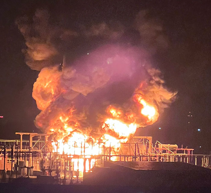 Flames and smoke rise dramatically from an explosion affecting Heathrow Airport flights.