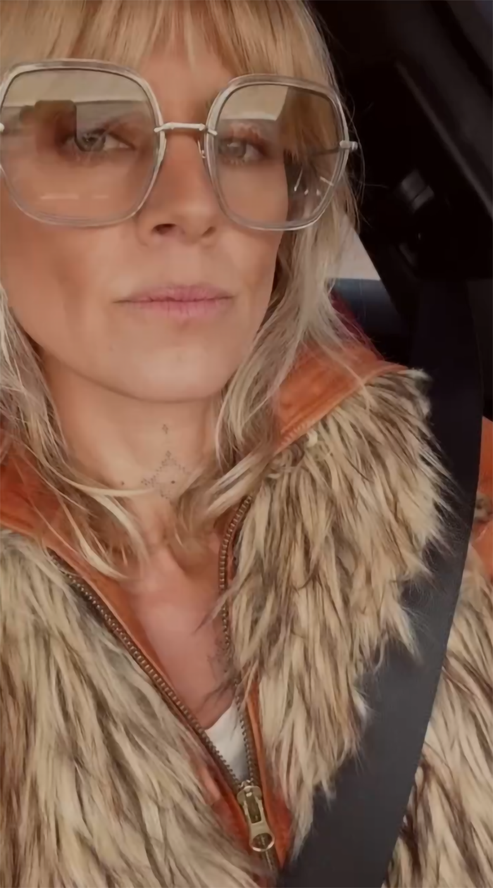 Eliza Coupe wearing large glasses and a fur vest after addressing Ozempic concerns at a premiere.