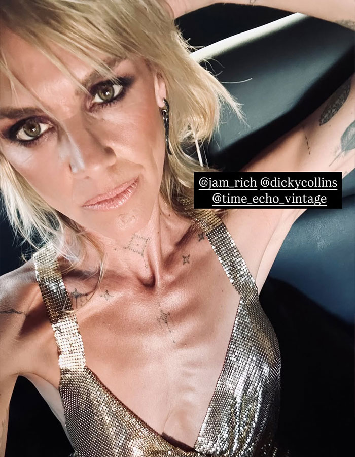 Scrubs star in gold top with tattoos, sparking fans' concern over post-divorce appearance.