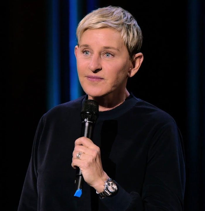 A person with short blonde hair holding a microphone, related to "Rosie O'Donnell Mocked Move Ireland.