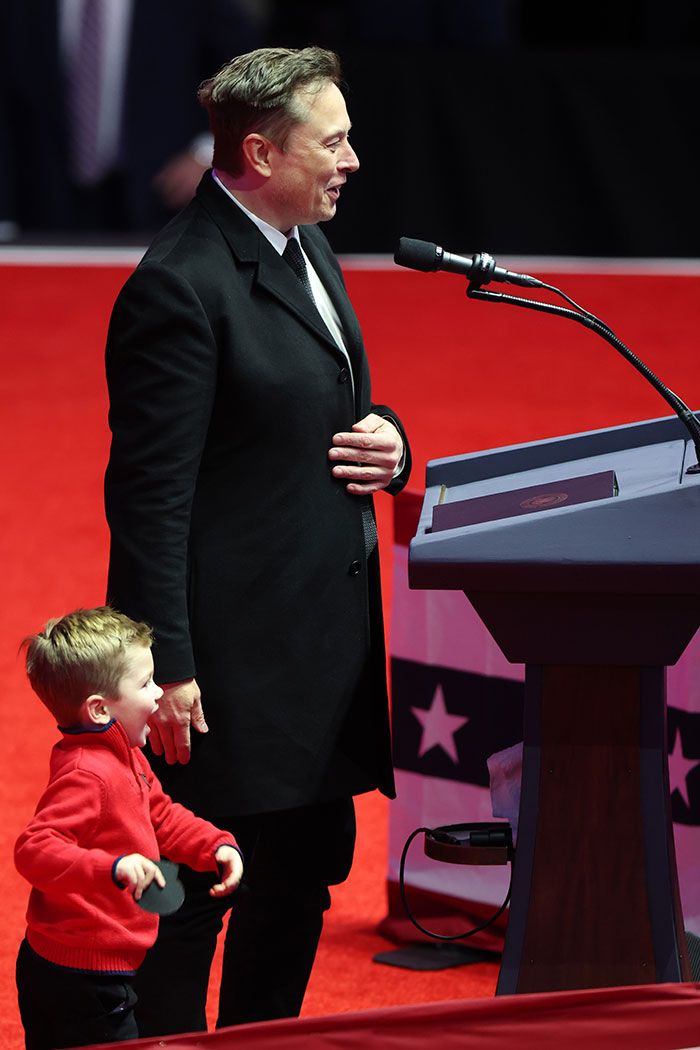 Man in black coat and child in red sweater at podium, related to controversy involving children&rsquo;s privacy.