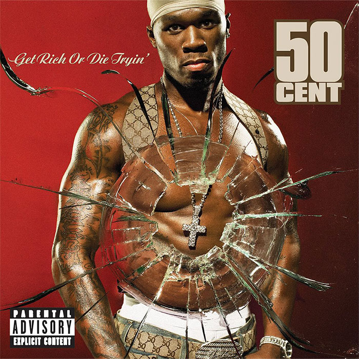 Rapper standing behind shattered glass with the album cover "Get Rich or Die Tryin'" by 50 Cent.