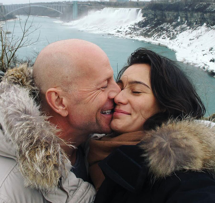 Couple embracing near a snowy riverbank, highlighting actor's dementia battle. Couple embracing near a snowy riverbank, highlighting actor's dementia battle.
