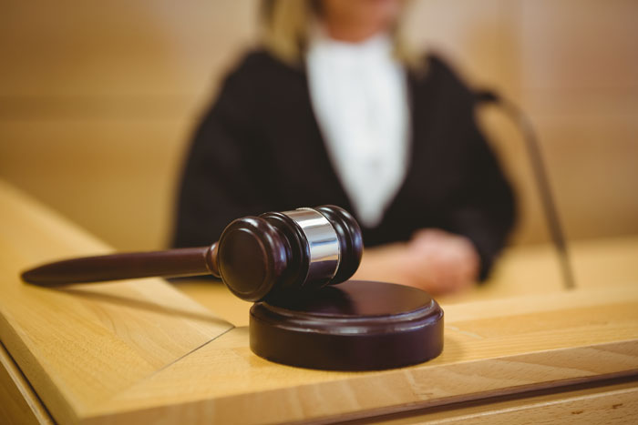 Gavel on a courtroom desk, symbolizing a workplace mistreatment lawsuit verdict. Gavel on a courtroom desk, symbolizing a workplace mistreatment lawsuit verdict.