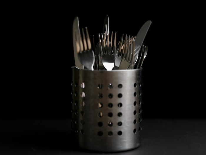 Silverware in a metal container, highlighting weird objects doctors have removed from bodies.