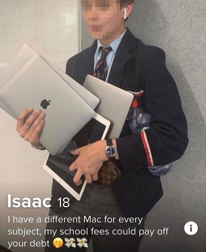 Teen in uniform holding multiple MacBooks, wearing AirPods, showcasing wealth.