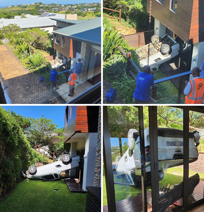 Car accident requiring expensive recovery, vehicle flipped and stuck in a peculiar position while being lifted by workers.