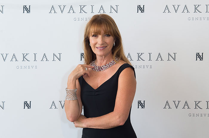 Celebrity woman in elegant black dress with jewelry at Avakian event.