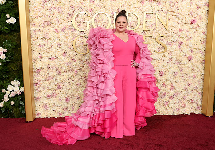 Celebrity woman in a pink ruffled gown at Golden Globes, highlighting fashion choices related to weight and age.
