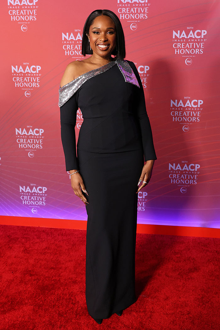 Celebrity woman in a black gown at NAACP Image Awards, highlighting issues in fashion industry related to weight and age.