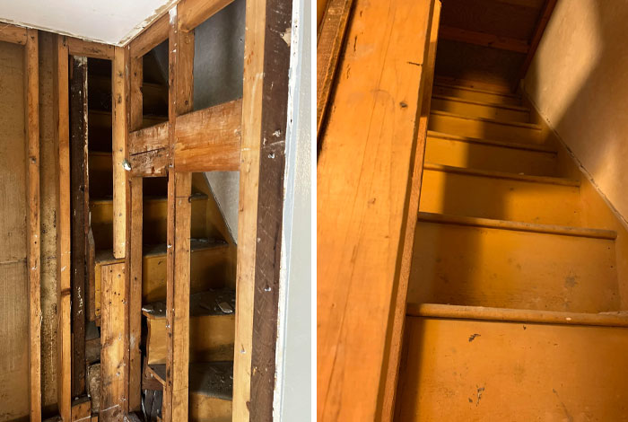 Hidden wooden staircase discovered behind a wall in an old house.