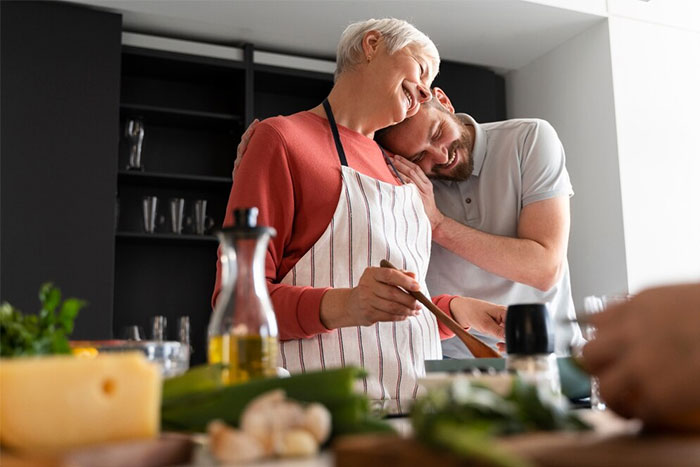 Man in kitchen with fianc&eacute;e cooking Hispanic meal, sharing an intimate moment together.