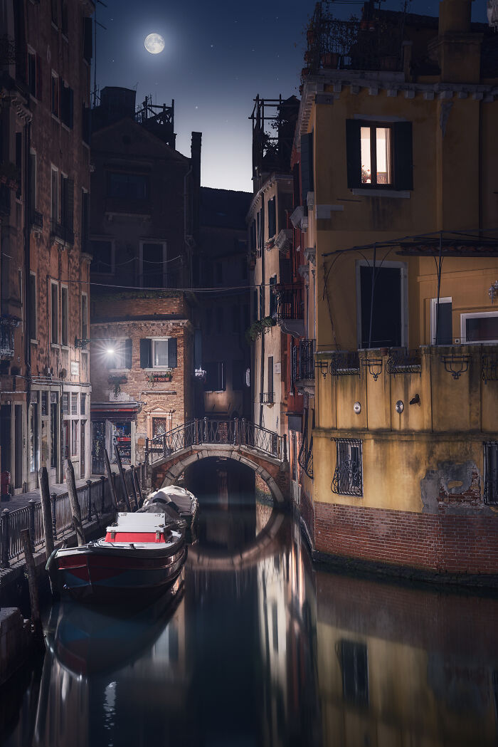 Stunning landscape in a moonlit canal scene with a starry sky.