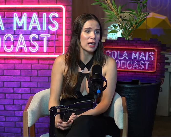 Woman discussing seat refusal consequences on a podcast, seated with a microphone. Woman discussing seat refusal consequences on a podcast, seated with a microphone.