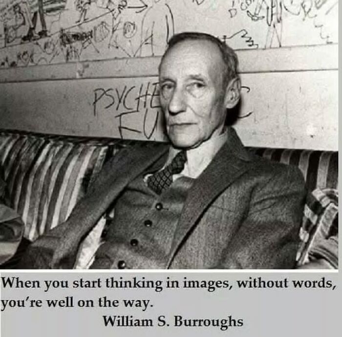 Black and white photo of a man in a suit with a quote on mental health. Graffiti covers the wall behind him.
