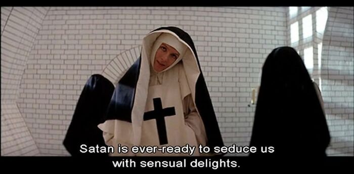 Nun with a cross on her habit gives an intense look, reflecting humor found in mental health memes.