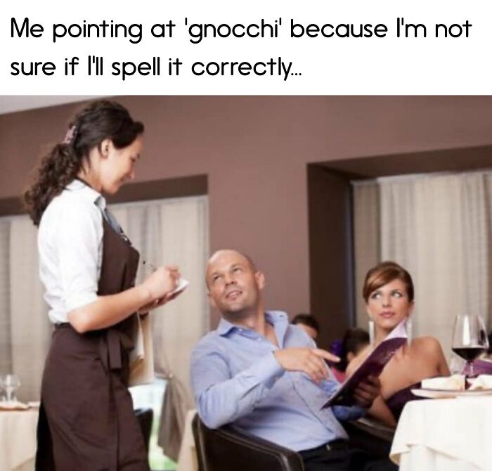 Man pointing at menu in restaurant, unsure how to spell 'gnocchi', while ordering food.