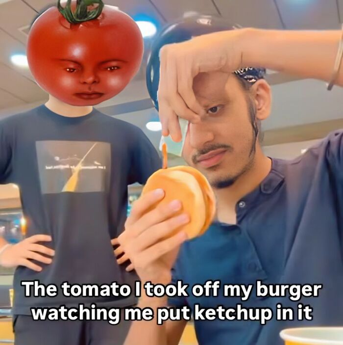 Man holding a burger, with a humorous tomato-head figure beside, illustrating a funny food meme scenario.