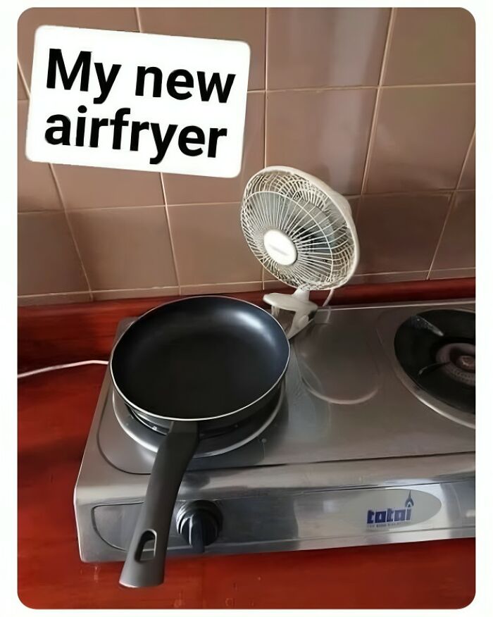Pan with a small fan labeled "My new air fryer" creating a funny food meme setup on a kitchen counter.