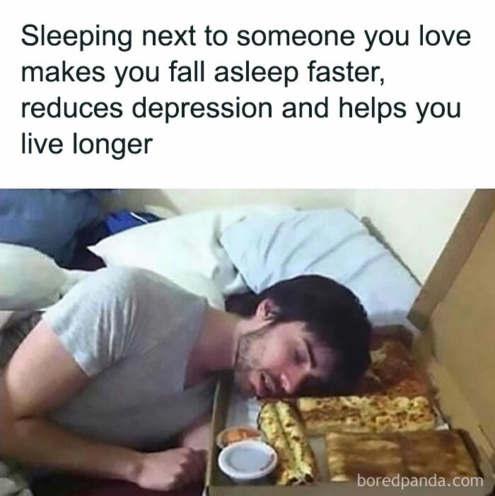 Man sleeping beside a pizza box, using pizza as a pillow, illustrates late-night food humor.