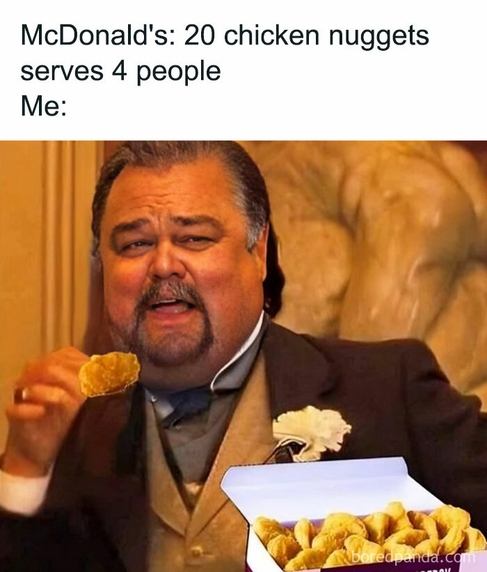 Man in a suit humorously eating McDonald's chicken nuggets, highlighting a funny food meme moment.