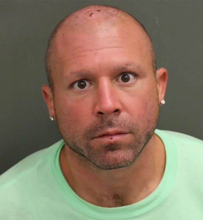 Bald man in a green shirt staring intently, associated with Florida man headlines.