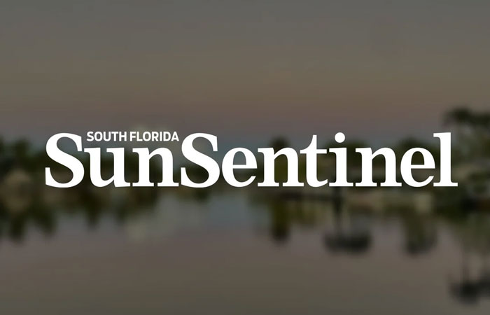 "South Florida Sun Sentinel logo on a blurred background."