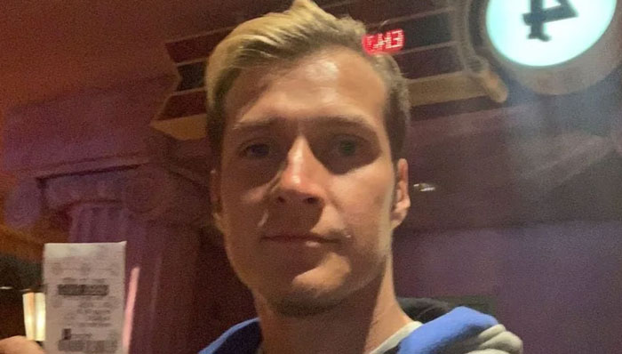 Man holding a receipt in a dimly lit room, representing a quirky Florida Man moment.