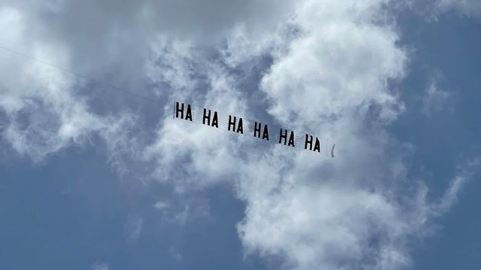 A plane flies a "HA HA HA" banner in the sky, echoing a classic Florida Man prank.