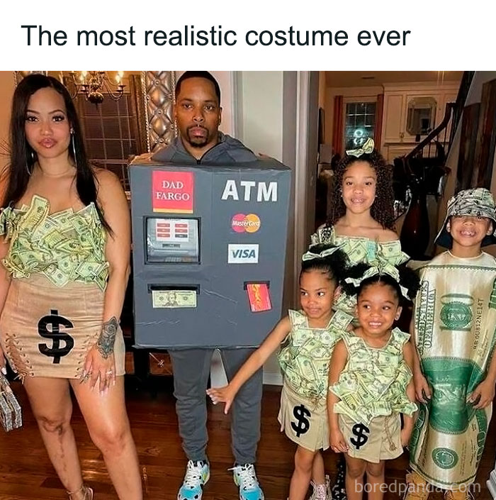Family in humorous ATM and money-themed costumes, showcasing sadcastic meme humor.