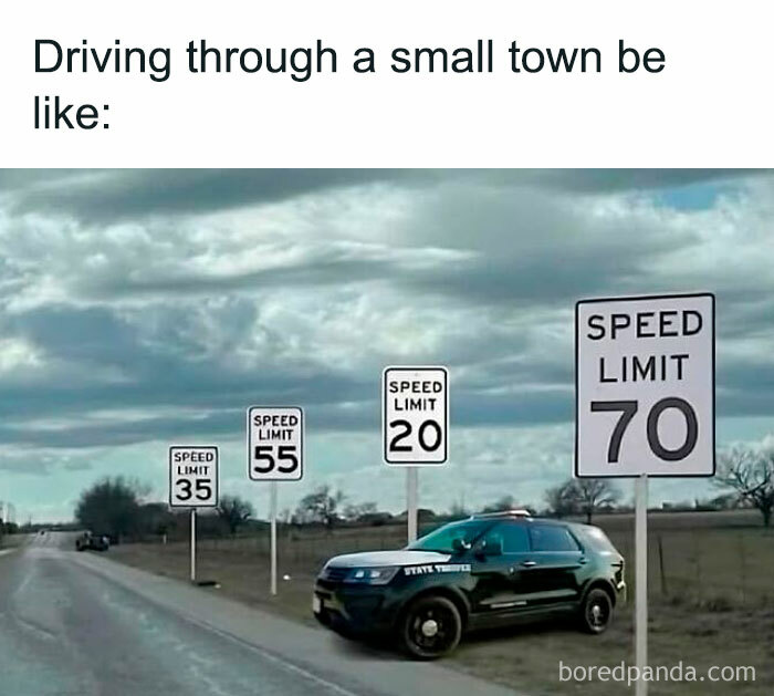 Police car parked with multiple speed limit signs displaying different limits, highlighting sarcasm in small town driving.