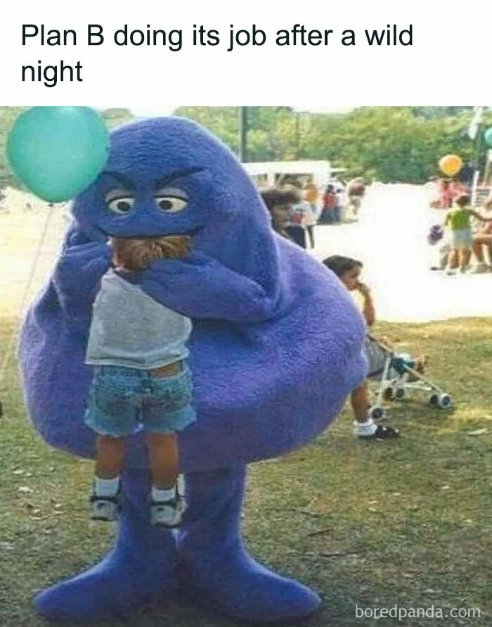 A large purple mascot humorously lifts a child in a park, capturing weirdness.