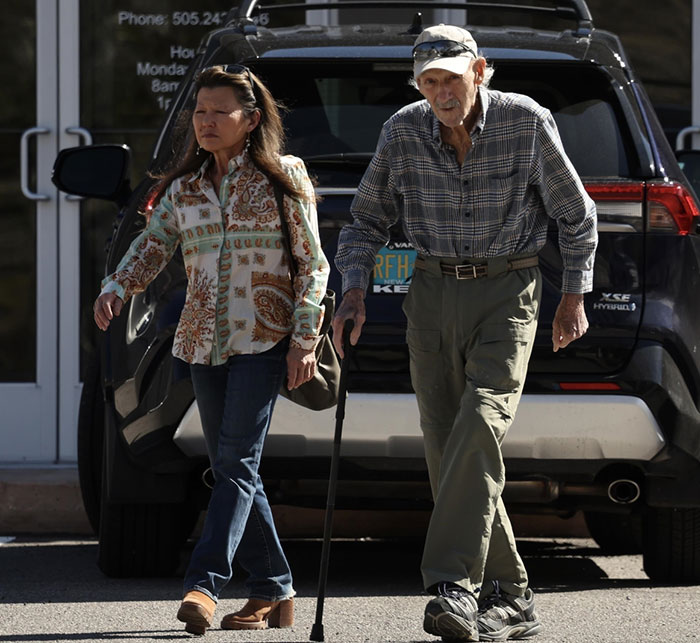 Man and woman walking outside together as Gene Hackman mystery deepens. Man and woman walking outside together as Gene Hackman mystery deepens.