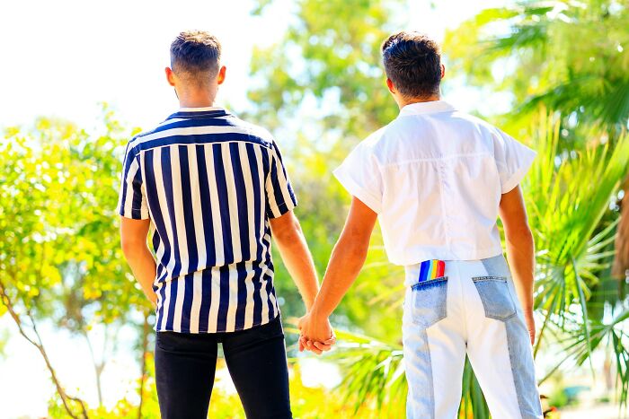 Two people holding hands, one in a striped shirt and the other in white, symbolizing things families may not know.